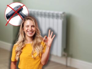 termosifoni in casa, donna che fa ok ed x rossa su asciugacapelli
