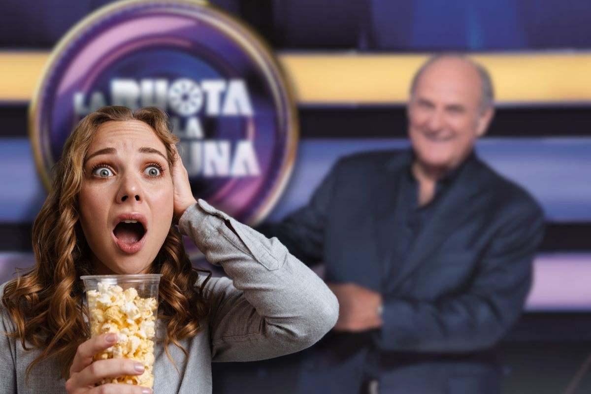 gerry scotti e la ruota della fortuna con donna sconvolta con pop corn in mano
